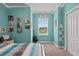 Bedroom with teal walls, guitar, and window seat at 9426 59 N St, Pinellas Park, FL 33782