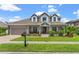 Two-story home with a large front yard, paver driveway and neutral color palette at 9426 59 N St, Pinellas Park, FL 33782