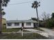 Charming single story home with a spacious yard and mature palm trees at 944 Bruce Ave, Clearwater Beach, FL 33767