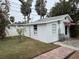 White guest house with a red awning and a walkway at 944 Bruce Ave, Clearwater Beach, FL 33767