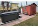 Dark brown hot tub with a red storage shed and patio at 944 Bruce Ave, Clearwater Beach, FL 33767