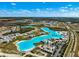 Overhead aerial view showing community and neighborhoods close to beach-like pool and facilities at 9804 Rowing Dale Bnd, Wesley Chapel, FL 33545