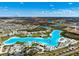 Sprawling overhead aerial view of a community including pools and many homes in neat neighborhood streets at 9804 Rowing Dale Bnd, Wesley Chapel, FL 33545