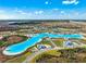 Wonderful aerial shot of the community, showcasing the expansive lagoon, beach, and luxurious residential homes at 9804 Rowing Dale Bnd, Wesley Chapel, FL 33545