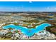 Beautiful aerial view of the community lagoon, featuring white sand beaches and turquoise blue water at 9804 Rowing Dale Bnd, Wesley Chapel, FL 33545