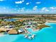 Beautiful aerial view of the community's recreation area, featuring a lagoon, pool and beach-style lounging at 9804 Rowing Dale Bnd, Wesley Chapel, FL 33545