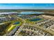 Gorgeous aerial view of a community featuring many homes near ponds and other bodies of water at 9804 Rowing Dale Bnd, Wesley Chapel, FL 33545