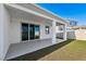 Covered back patio with sliding glass doors, offering easy indoor-outdoor flow at 9804 Rowing Dale Bnd, Wesley Chapel, FL 33545