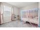 Light-filled bedroom featuring a twin bed with sheer canopy and soft pink accents at 9804 Rowing Dale Bnd, Wesley Chapel, FL 33545