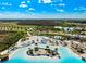 Amazing view of beach with soft sand, turquoise water and lounging areas, creating a tropical paradise atmosphere at 9804 Rowing Dale Bnd, Wesley Chapel, FL 33545