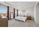 Main bedroom featuring large windows, a tray ceiling and ensuite bathroom at 9804 Rowing Dale Bnd, Wesley Chapel, FL 33545