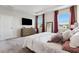 Main bedroom featuring large windows, a tray ceiling, and ensuite bathroom at 9804 Rowing Dale Bnd, Wesley Chapel, FL 33545