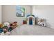 Bright playroom featuring a playhouse, toy kitchen, and an abundance of plush toys at 9804 Rowing Dale Bnd, Wesley Chapel, FL 33545