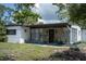 Ranch style home with a stone accent and well-manicured lawn at 5601 9Th N Ave, St Petersburg, FL 33710