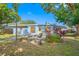 View of the home's back, showcasing a patio and landscaping at 10 N Mercury Ave, Clearwater, FL 33765