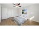 Bedroom with wood-look floors, window, and ceiling fan at 10 N Mercury Ave, Clearwater, FL 33765