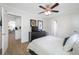 Spacious bedroom with a queen bed, dresser, and kitchen view at 10 N Mercury Ave, Clearwater, FL 33765