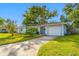 Front view of a light blue house with a white garage door at 10 N Mercury Ave, Clearwater, FL 33765