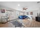 Living area with hardwood floors, blue sofa, and window at 10 N Mercury Ave, Clearwater, FL 33765