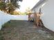 Backyard with a small deck, featuring wooden stairs and a partial privacy fence at 10008 N 20Th St, Tampa, FL 33612