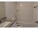 Clean, bright bathroom featuring a tiled shower and tub combo and granite countertop at 10008 N 20Th St, Tampa, FL 33612