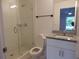 Modern bathroom with a glass-enclosed shower, granite vanity top, and sleek fixtures at 10008 N 20Th St, Tampa, FL 33612