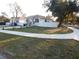 Pleasant view of two homes with matching exteriors, set back from a sidewalk at 10008 N 20Th St, Tampa, FL 33612