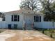 Newly constructed house with a concrete driveway and fenced yard at 10008 N 20Th St, Tampa, FL 33612