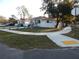 Street view of a well-maintained home with manicured landscaping and a white privacy fence at 10008 N 20Th St, Tampa, FL 33612