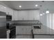 Modern kitchen with white cabinets and granite countertops at 10008 N 20Th St, Tampa, FL 33612