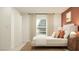 Bedroom with a bed, terracotta wall, and neutral decor at 10236 Alder Green Dr, Riverview, FL 33578