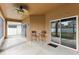 Covered patio featuring a ceiling fan, textured walls, and sliding glass doors at 10757 Carloway Hills Dr, Wimauma, FL 33598