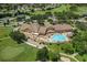 Aerial view showcasing community clubhouse, pool, golf course, and surrounding homes at 11121 Sun Tree Rd, Hudson, FL 34667