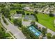 Aerial view of community tennis and pickle ball courts with surrounding homes and parking at 11121 Sun Tree Rd, Hudson, FL 34667