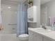 Bathroom featuring a shower and tub combination, a white vanity, and ample lighting at 11121 Sun Tree Rd, Hudson, FL 34667