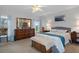 Comfortable bedroom with a large bed, dresser, ceiling fan, and bright natural light at 11121 Sun Tree Rd, Hudson, FL 34667