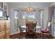 Cozy breakfast nook with bay windows and a charming chandelier at 11121 Sun Tree Rd, Hudson, FL 34667