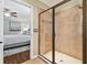 Modern bathroom with a glass-enclosed shower featuring tile surround and neutral-colored flooring at 11132 Roseate Dr, Tampa, FL 33626