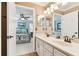 Dual sink bathroom with white cabinets and decor, seen from bedroom at 11132 Roseate Dr, Tampa, FL 33626