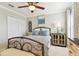 Bedroom with ceiling fan, white closet doors, and bright decor at 11132 Roseate Dr, Tampa, FL 33626