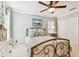 Bright bedroom featuring ceiling fan, closet, and light grey walls at 11132 Roseate Dr, Tampa, FL 33626