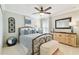 Cozy bedroom with iron bed frame, ceiling fan, and light, airy decor at 11132 Roseate Dr, Tampa, FL 33626