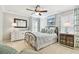 Airy bedroom with ceiling fan, large window, and serene decor at 11132 Roseate Dr, Tampa, FL 33626