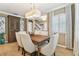 Elegant dining area featuring decorative lighting, a wooden table with seating for six at 11132 Roseate Dr, Tampa, FL 33626