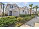 Charming two-story home with a lush green lawn and beautiful landscaping at 11132 Roseate Dr, Tampa, FL 33626