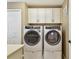 Well-organized laundry room with stacked washer and dryer at 11132 Roseate Dr, Tampa, FL 33626