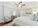 Well-lit main bedroom with a queen-sized bed, neutral color palette, and ceiling fan at 11132 Roseate Dr, Tampa, FL 33626