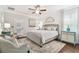 Bright main bedroom features a ceiling fan, shiplap accent wall, and light wood flooring at 11132 Roseate Dr, Tampa, FL 33626