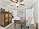 Bright home office with a wooden desk, patterned rug, and neutral colored walls at 11132 Roseate Dr, Tampa, FL 33626