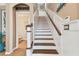 Elegant staircase with wood treads, white risers, and stylish railing leading to upper level at 11132 Roseate Dr, Tampa, FL 33626